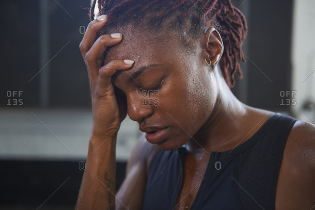 Portrait of frustrated Black woman sweating