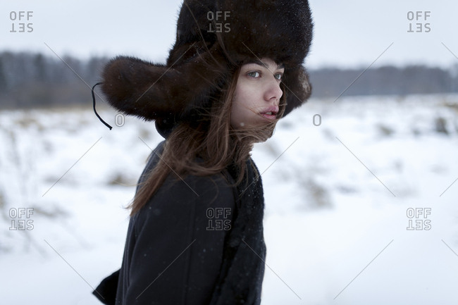 Serious Caucasian woman wearing fur hat and coat in winter