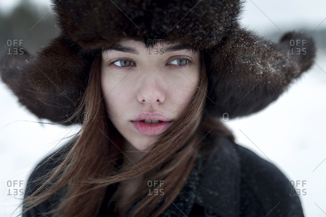 Serious Caucasian woman wearing fur hat and coat in winter