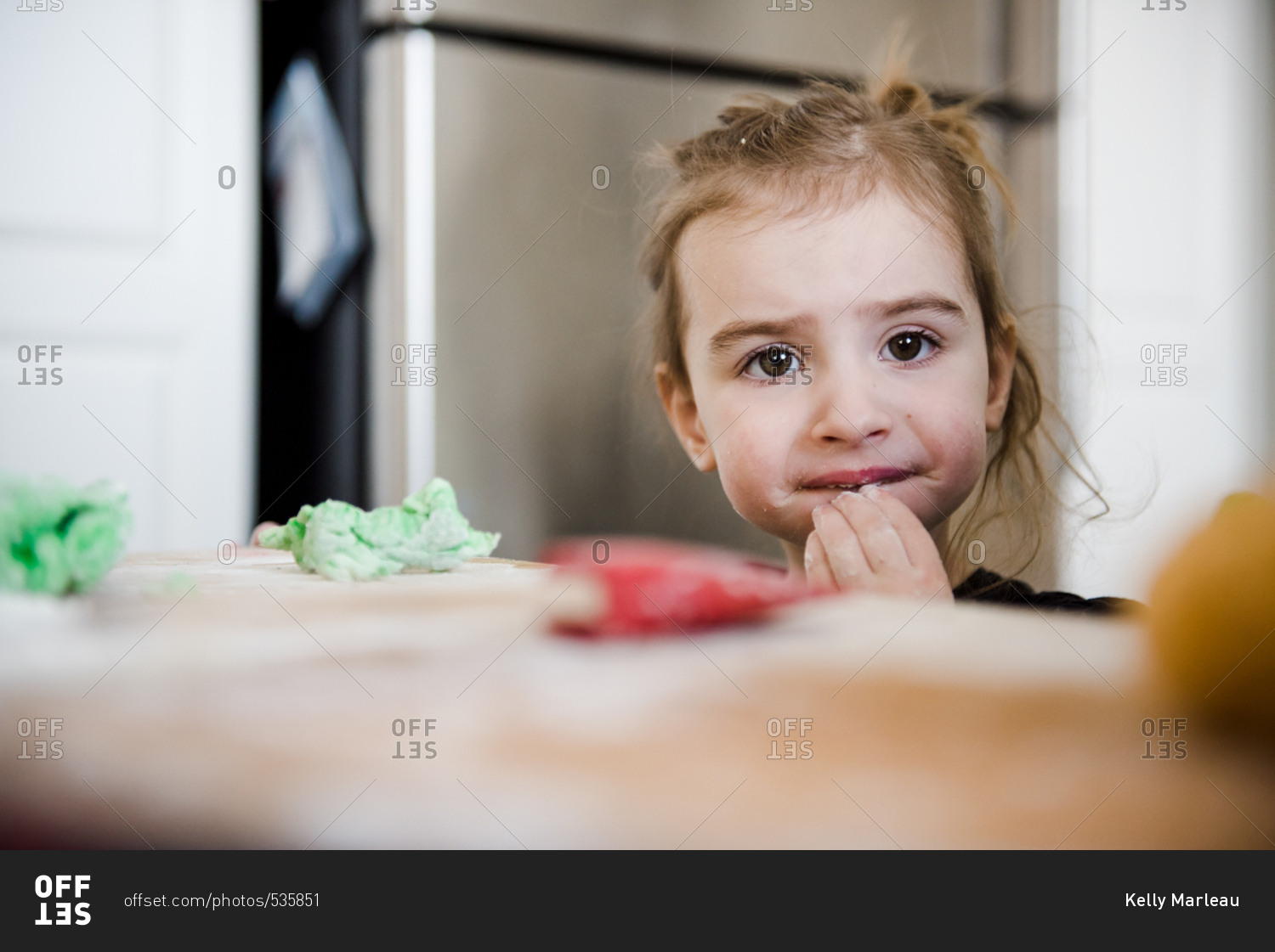 Toddler girl eating cookie dough
