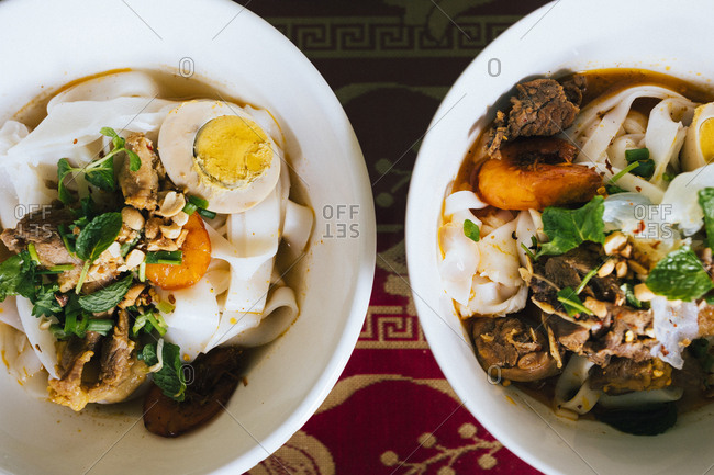 Bowls of Mi Quang noodles with pork and shrimp in Danang, Vietnam.