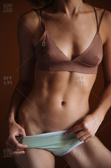 woman pulling underwear stock photos - OFFSET