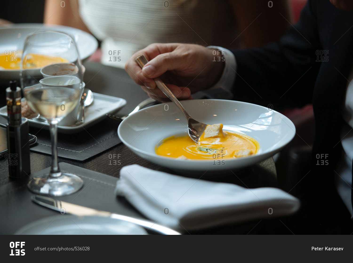 Groom eating soup at wedding