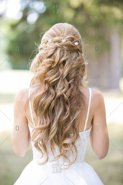 Bride with long, blonde curly hair stock photo - OFFSET