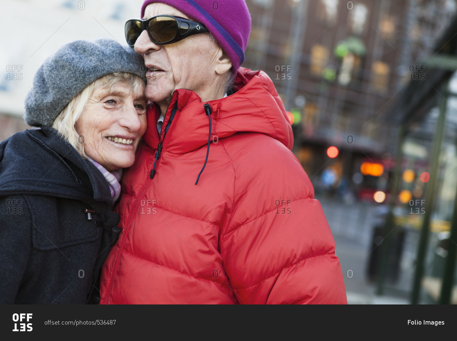 Sweden, Stockholm, Sodermalm, Senior couple hugging at bus stop