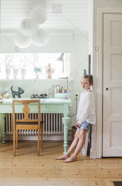 Sweden, Girl leaning on wall in room