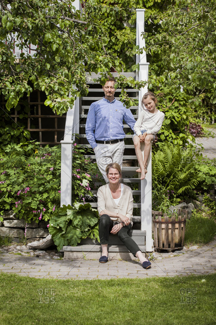 Sweden, Vastmanland, Vasteras, Portrait of family with daughter in backyard