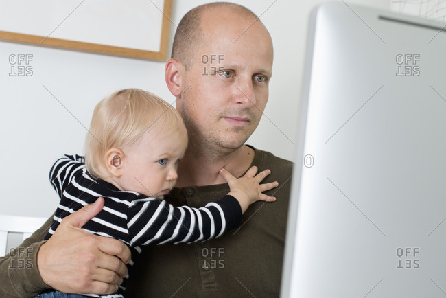 Sweden, Stay at home dad with son using computer