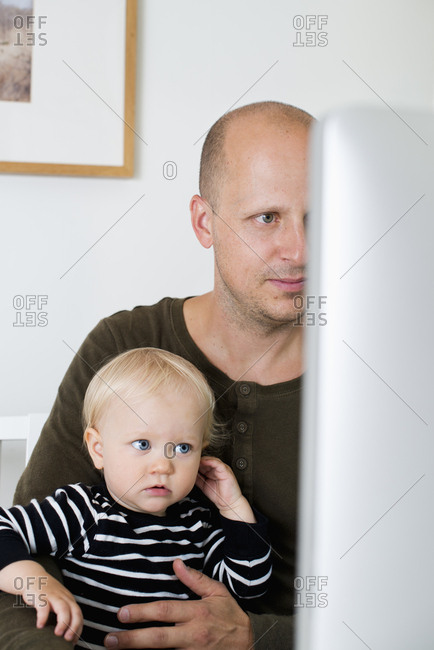 Sweden, Stay at home dad with son using computer
