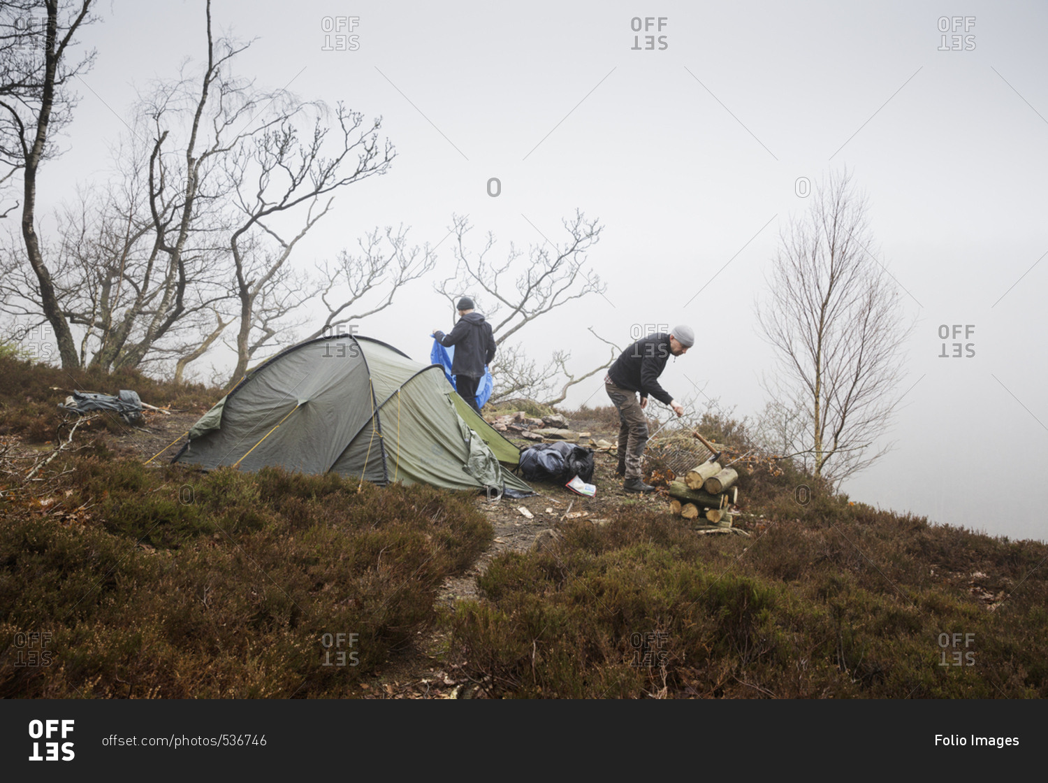 Sweden, Skane, Soderasen, Two men camping on grassy hill