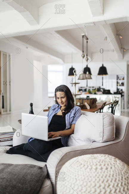 Germany, Woman using computer with concentration