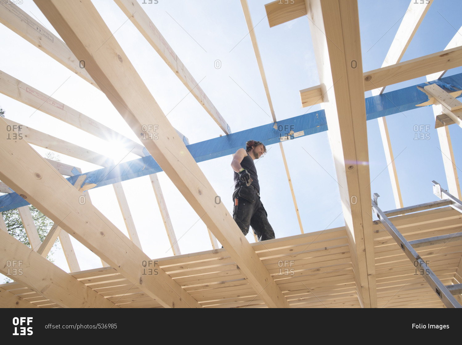Sweden, Sodermanland, Low angle view of carpenter working on construction site
