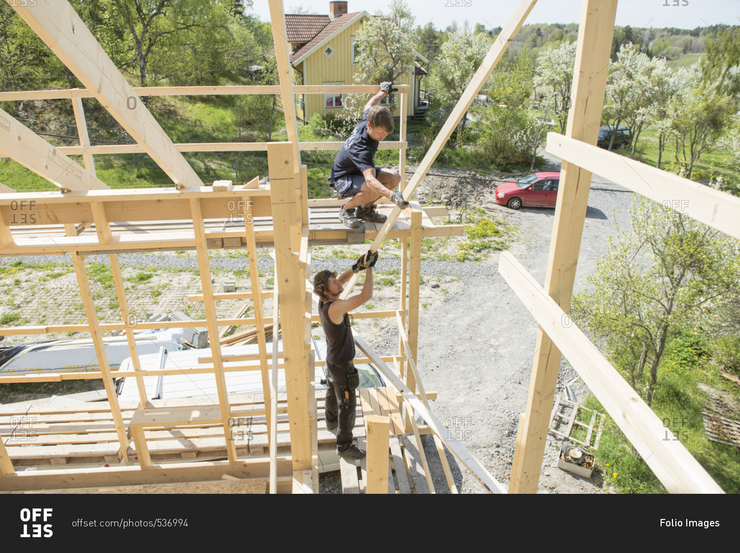 Sweden, Sodermanland, Mid adult men constructing wooden building