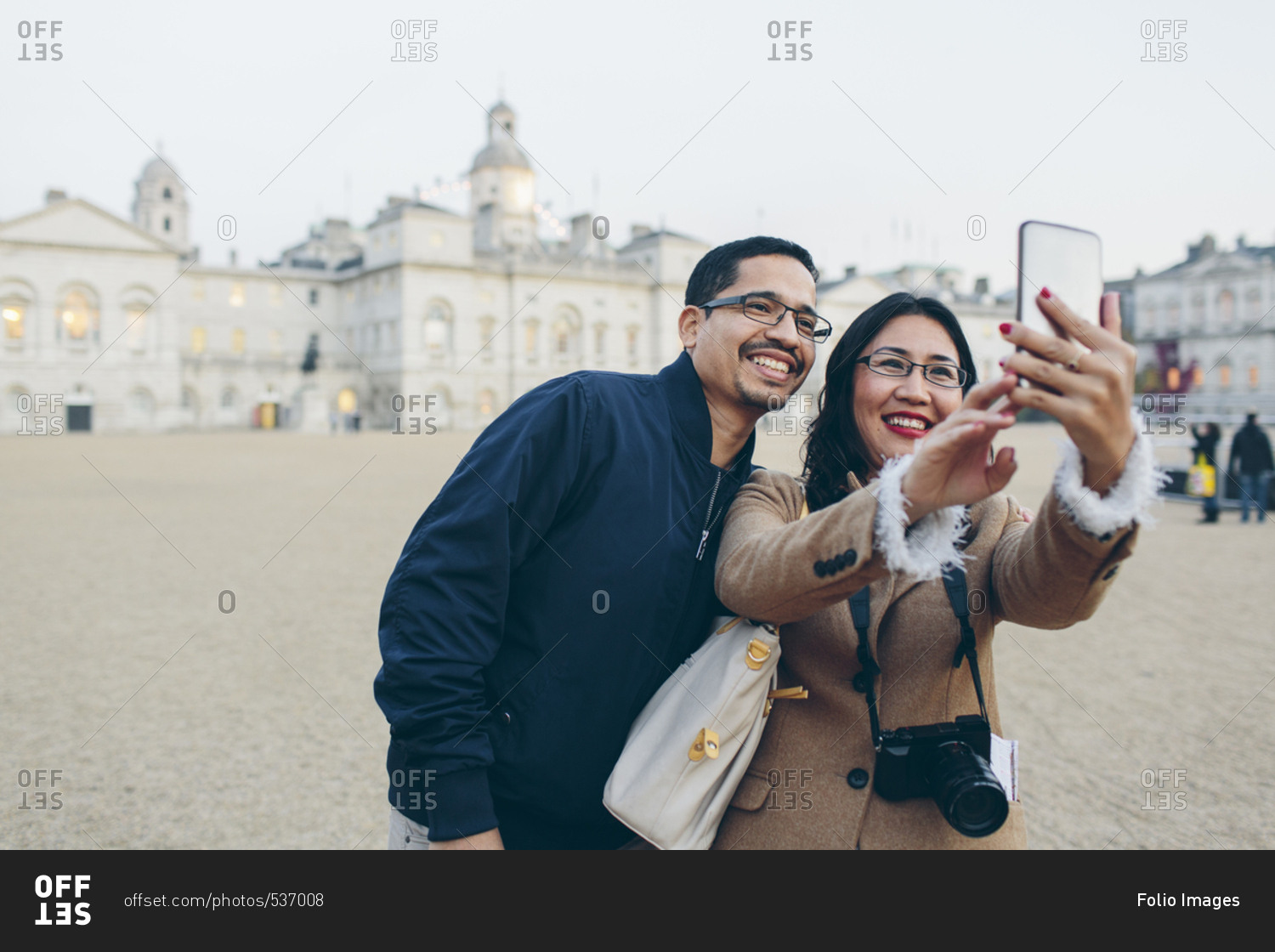 UK, England, London, Mid adult man and woman taking selfies with Horse Guards Parade in background