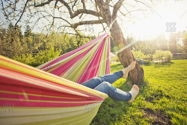 Finland, Paijat-Hame, Heinola, Low section of mid adult woman lying down on hammock