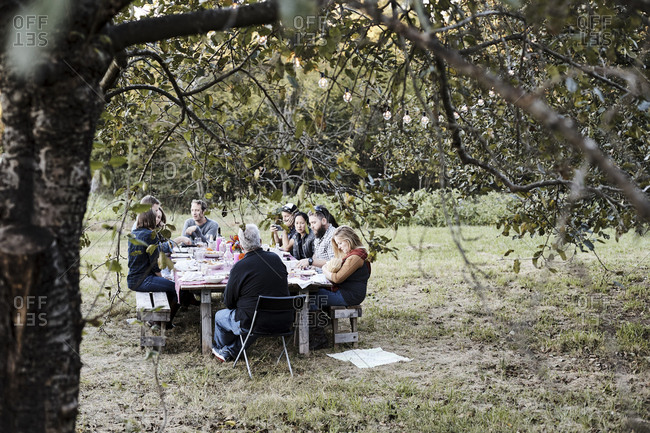 Virginia, USA - October 23, 2016: People at dining table on farm