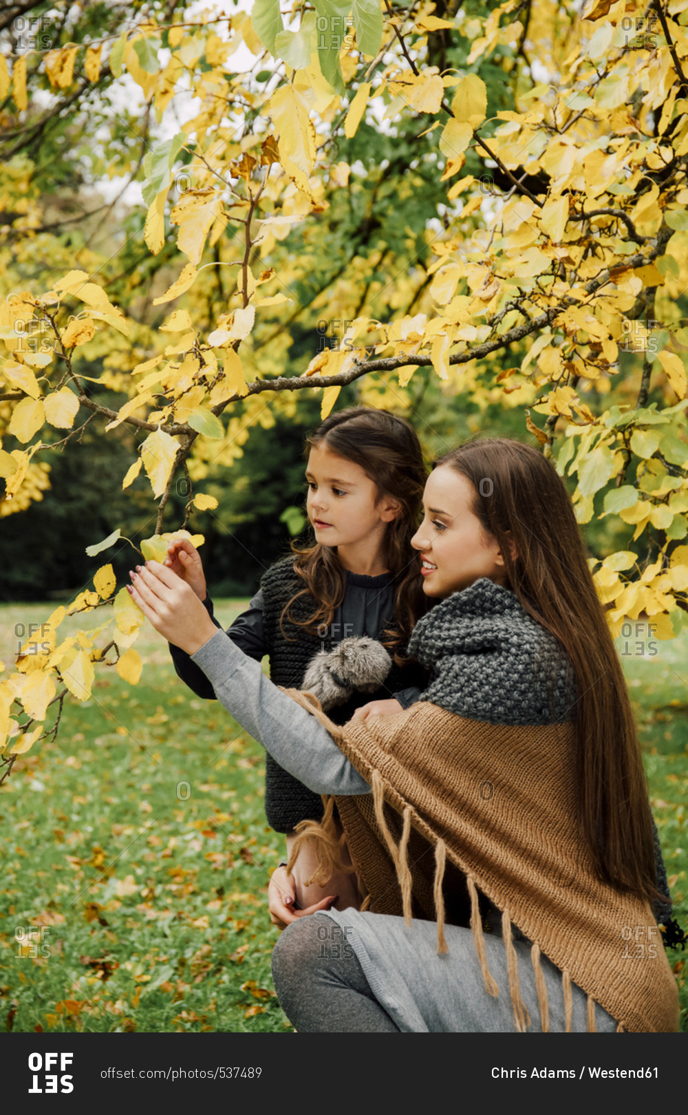 Young woman and little girl in autumn