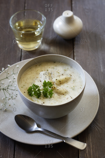 Cream of white asparagus soup garnished with asparagus spears and parsley