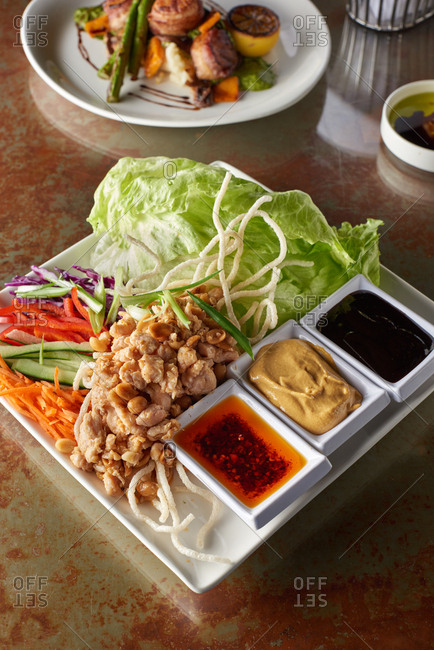All the pieces for chicken lettuce wraps including sauteed chicken, lettuce, red pepper, carrots, cucumber and cabbage