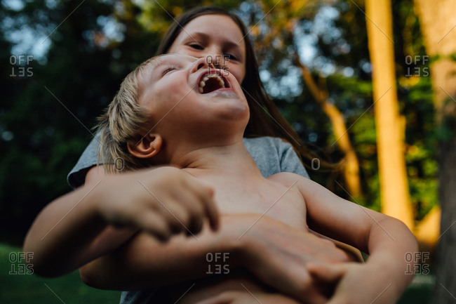 Kids laughing and hugging outdoors