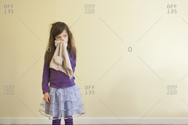 Sick Caucasian girl wiping nose