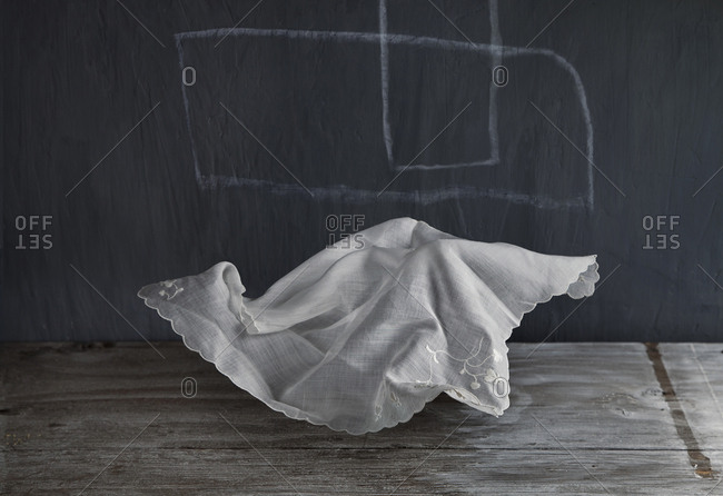 Wrinkled napkin floating near chalkboard