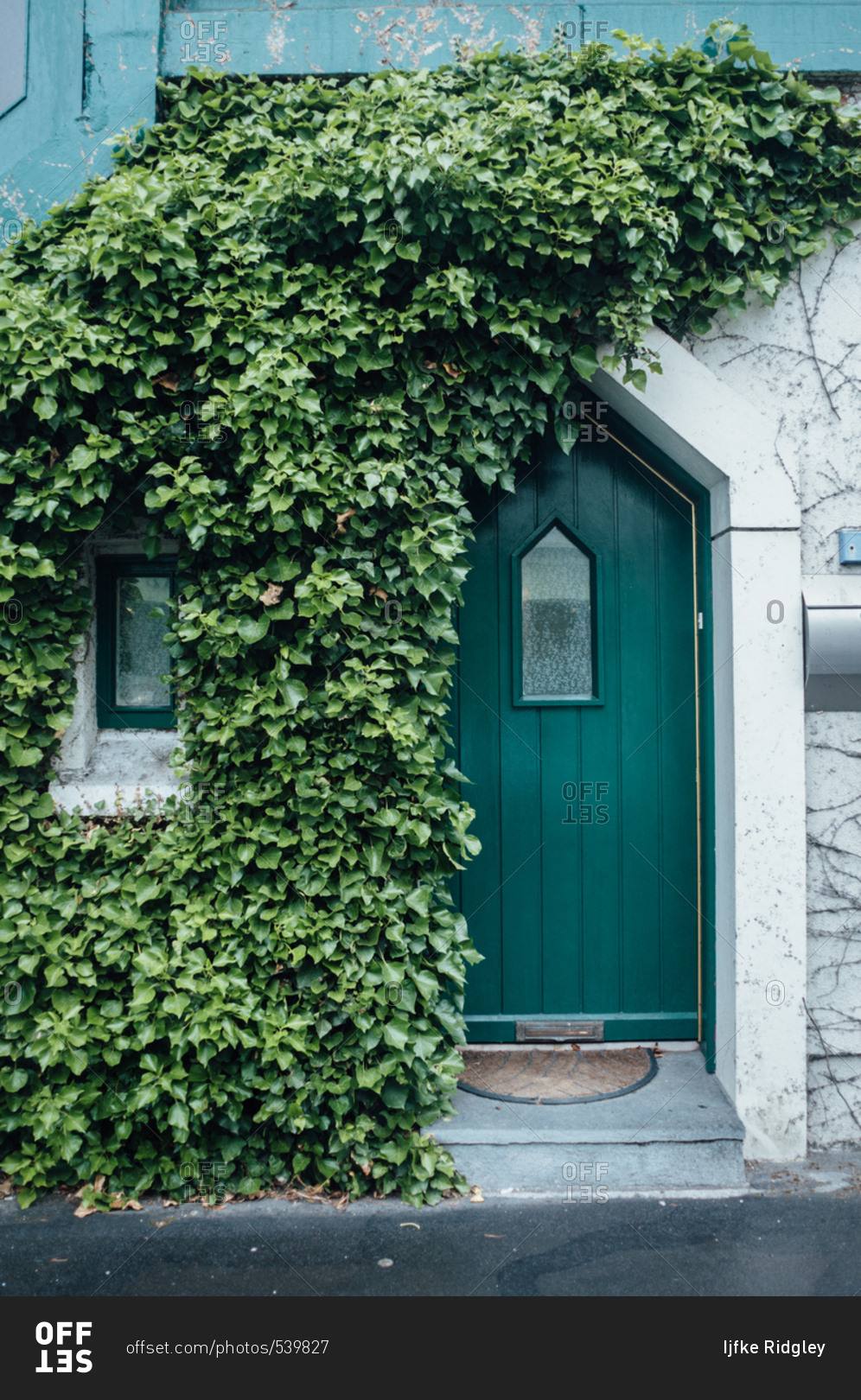 Green door on a house, Ireland stock photo - OFFSET