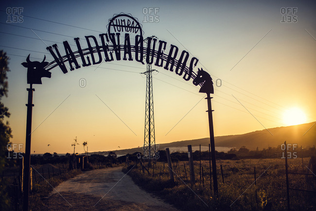 Tarifa, Spain - May 20, 2016: Sign over a dirt path to Valdevaqueros Beach at sunset