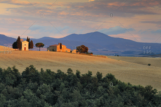 Typical Orcia Valley landscape with a small farmhouse and Vitaleta church between Pienza and San Quirico d'Orcia villages