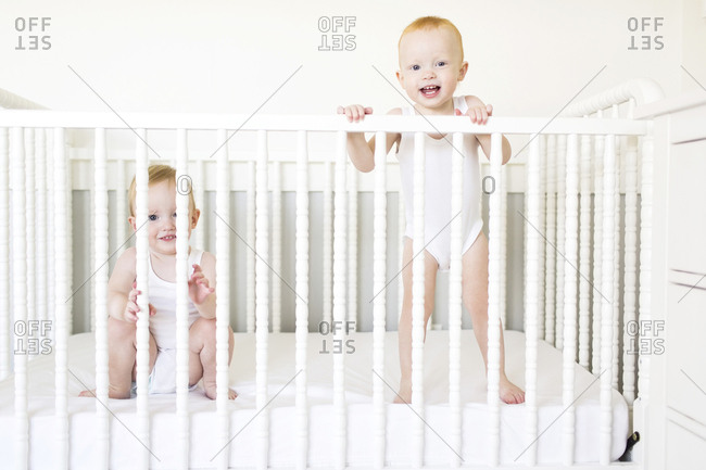 Twin Brothers Playing In Crib Stock Photo Offset