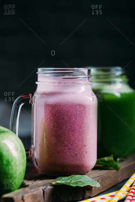 Green detox smoothie with apple and spinach and pink smoothie with berries