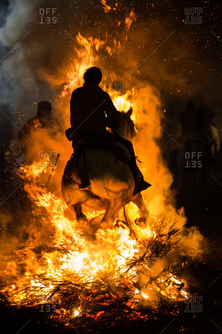 Horse riding through bonfire in a purification ritual