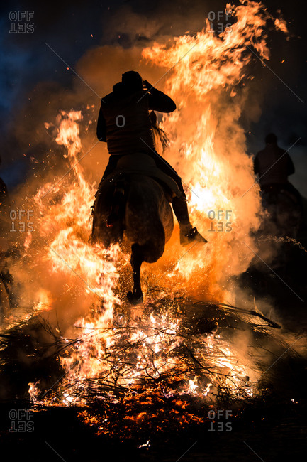 Horse riding through bonfire in a purification ritual