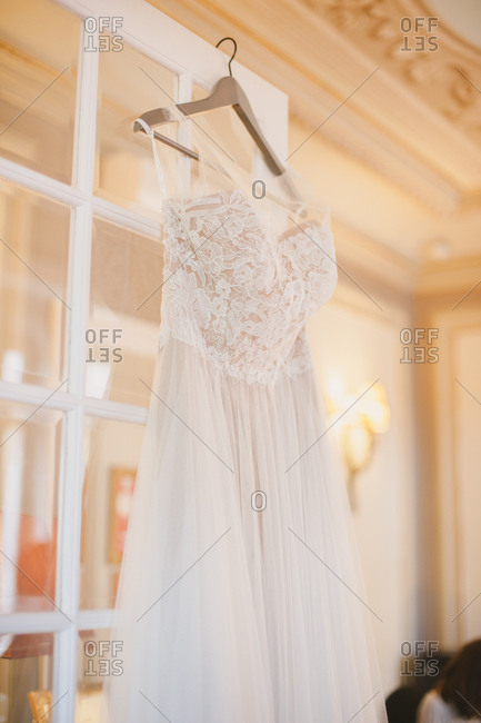 White Wedding Gown On A Wooden Hanger Stock Photo Offset