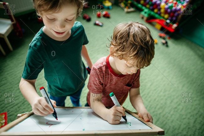Children having fun writing on a drawing board
