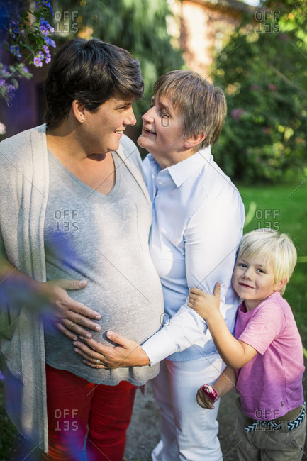 Pregnant Lesbian Couple Embraced With Their Son Stock Photo Offset