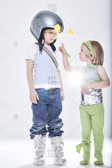 Girl dressed up as alien getting in contact with boy dressed up as spaceman