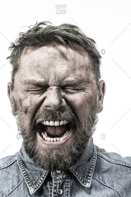 Portrait of screaming man with dirty face