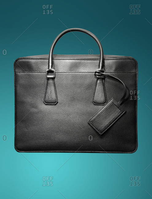 Black leather briefcase on a blue background