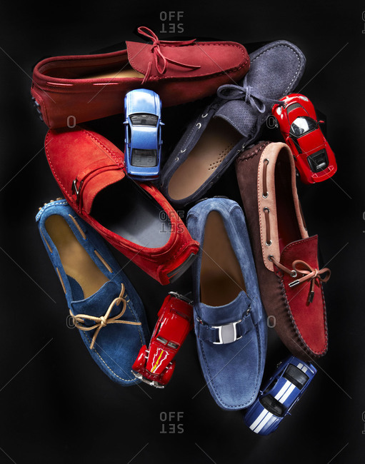 Red and blue men\'s loafers and toy cars