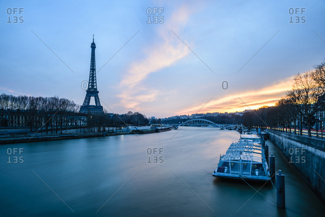 France, Paris - February 28, 2016: Eiffel Tower by river against sky at dusk