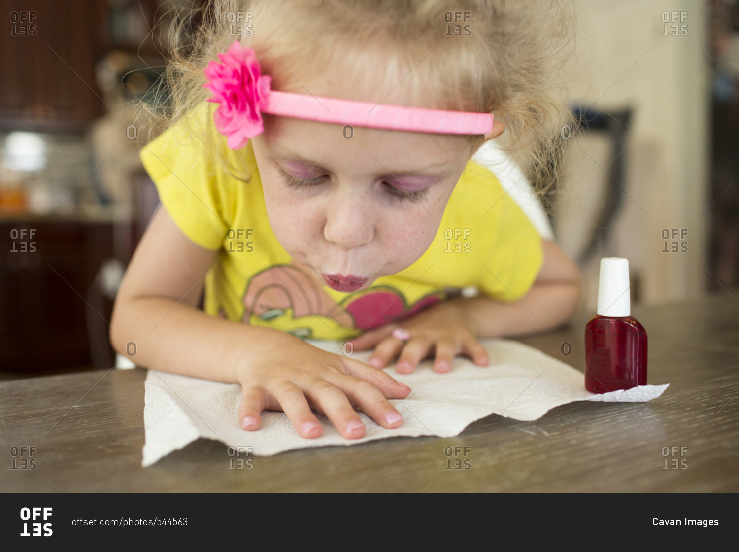 Girl painting fingernails at home
