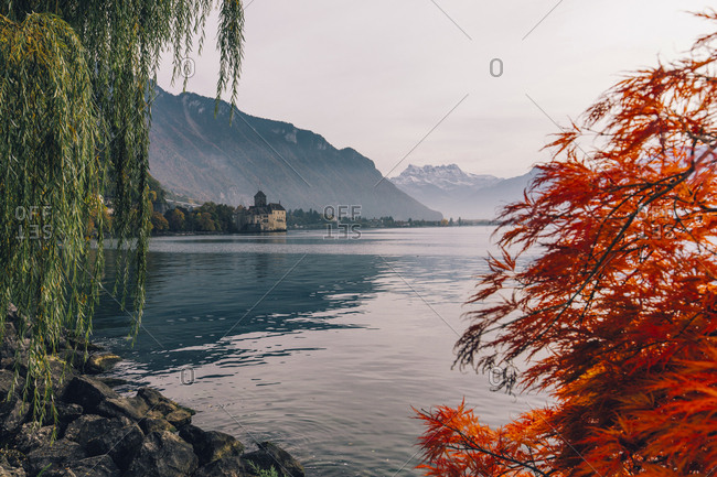 Distant view of Chillon Castle by Lake Geneva against sky