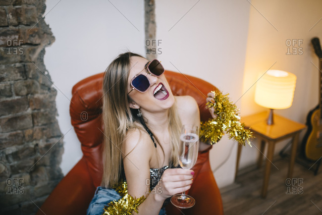 Young woman drinking champagne and having fun
