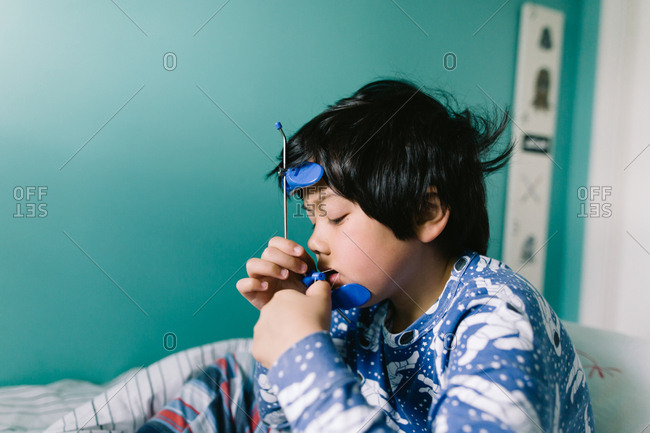 Boy adjusting his orthodontic headgear