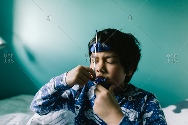 Boy taking out his orthodontic headgear