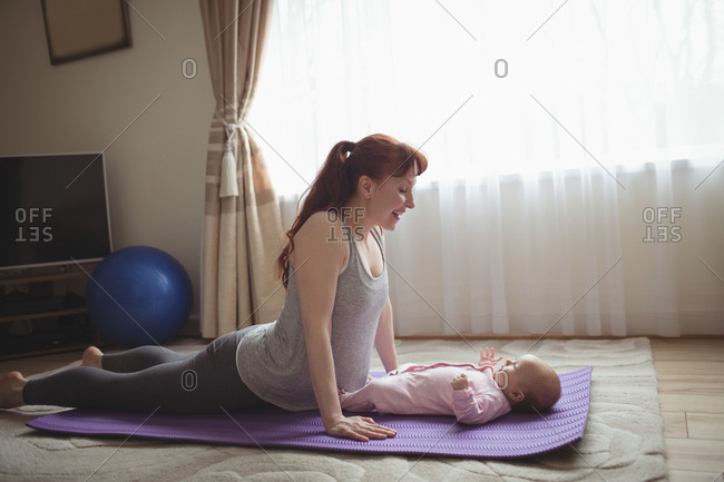 Smiling Little Girl Doing Yoga Pose Home Adorable Happy Child Stock Photo  by ©vadimphoto1@gmail.com 211089754