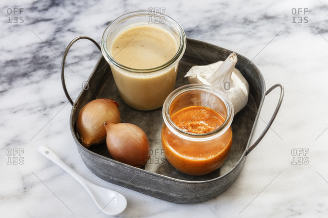 Jars with tomato sauce- peanut sauce- onions and garlic