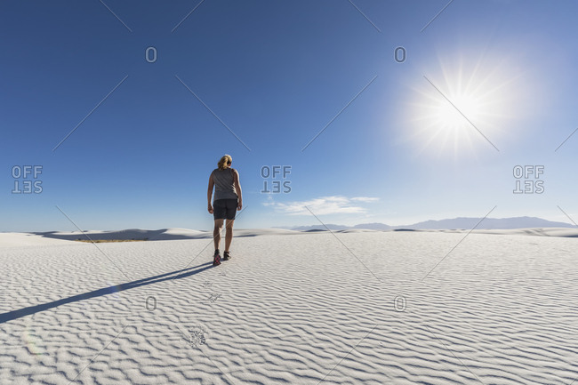 USA- New Mexico- Chihuahua Desert- White Sands National Monument- woman hiking on dune