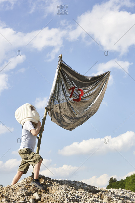 Little boy dressed up as spaceman playing moon landing